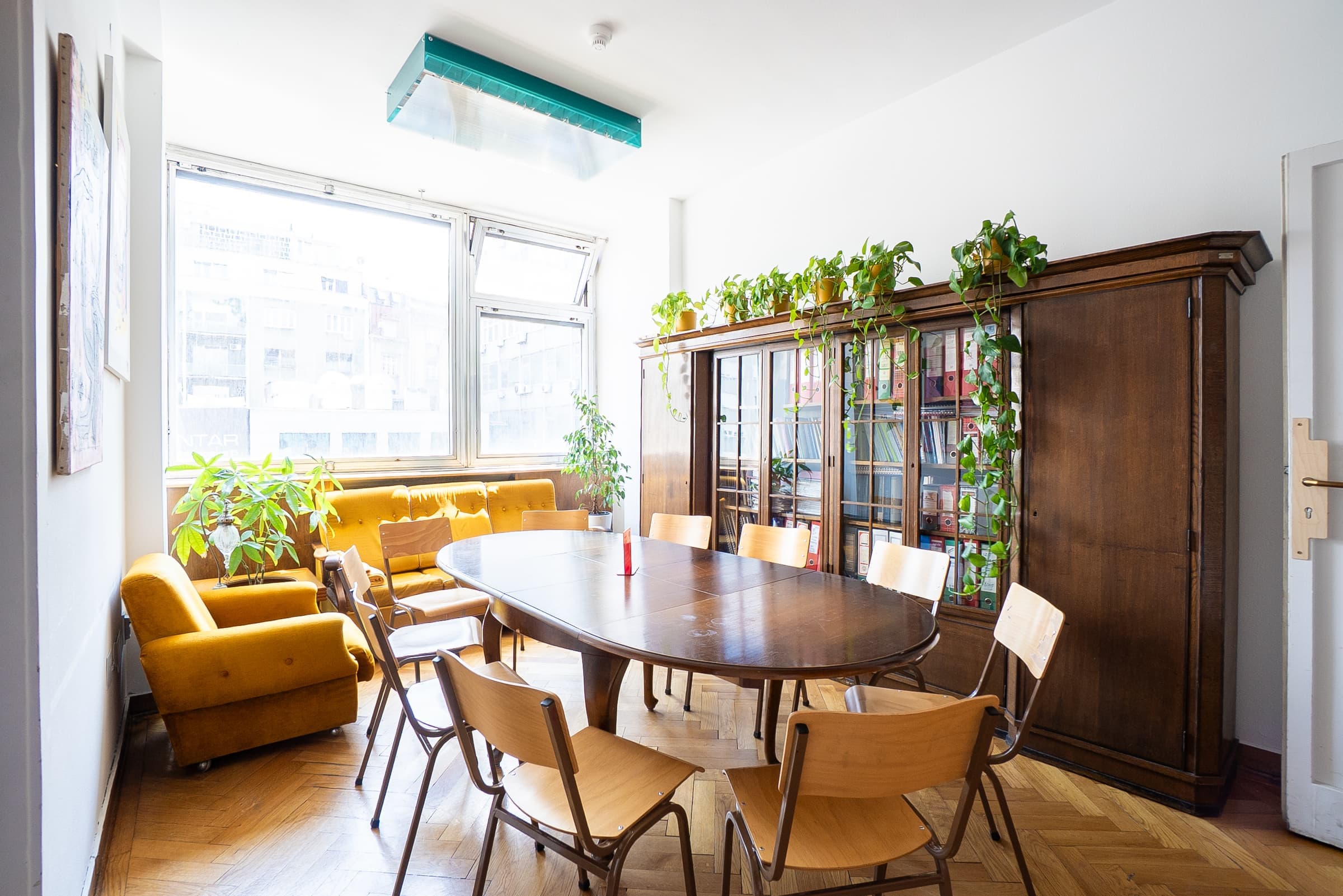 Meeting Room at SENSE—S.SPACE with oval conference table and sunlit window seating